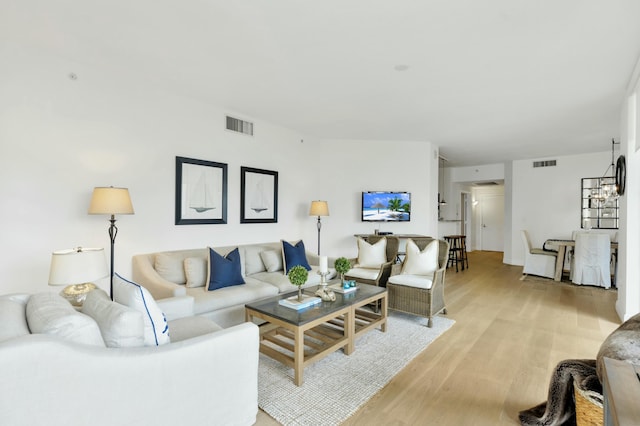 living area with visible vents and light wood finished floors