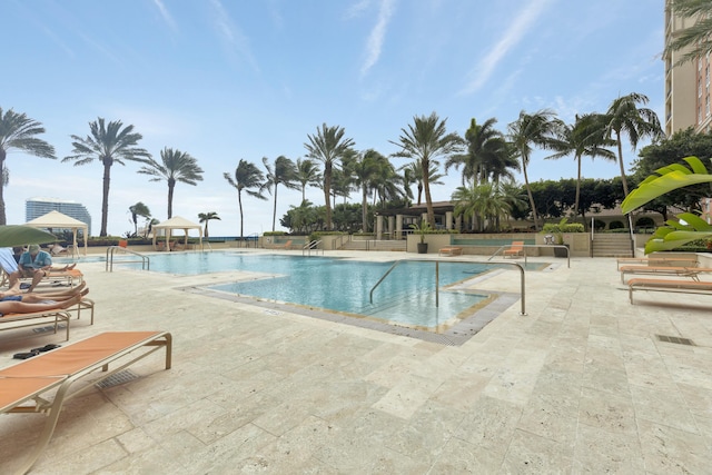 pool featuring a patio and a gazebo