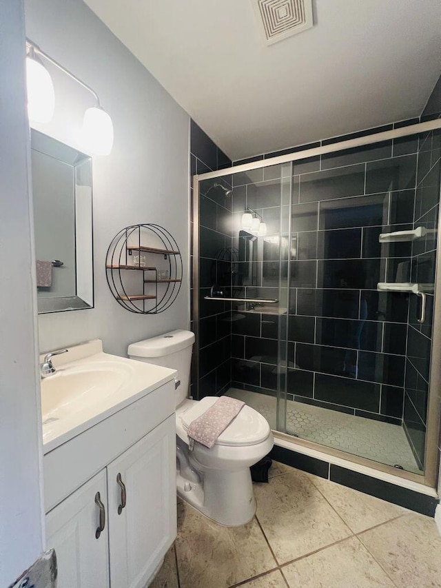 full bathroom featuring visible vents, vanity, a stall shower, and toilet