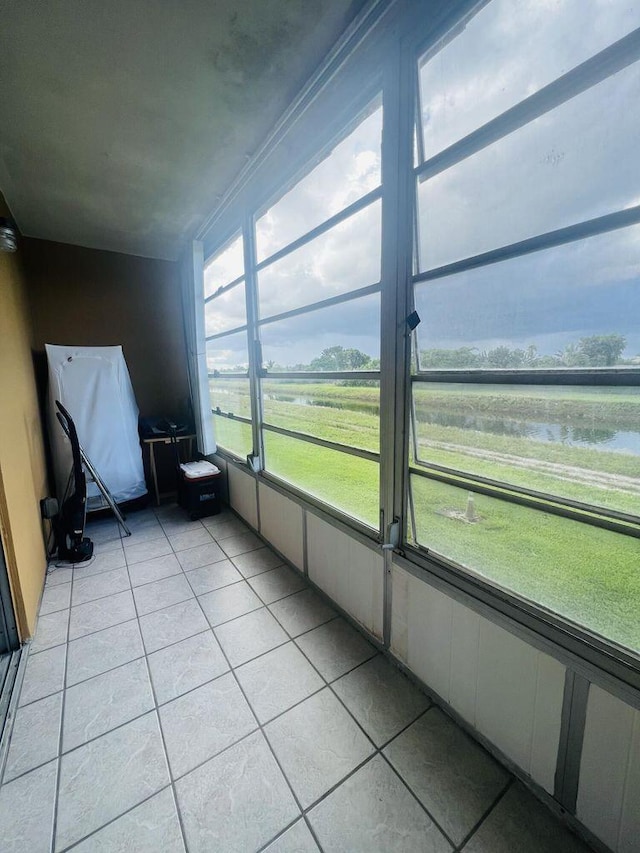 unfurnished sunroom with a water view