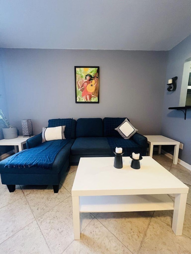 living area featuring baseboards