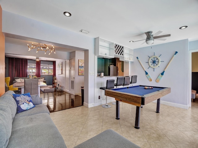 game room with light tile patterned flooring, billiards, ceiling fan with notable chandelier, and baseboards
