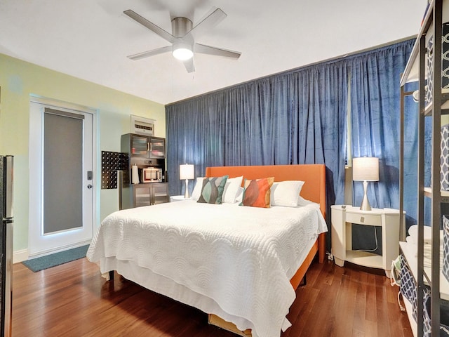 bedroom with ceiling fan and wood finished floors