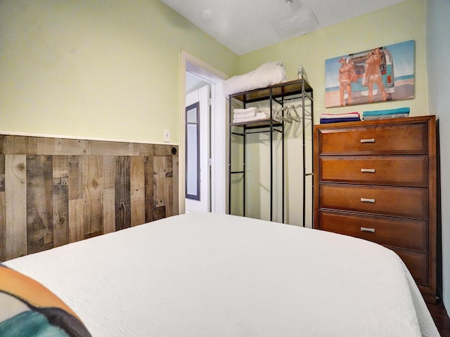 bedroom with a wainscoted wall