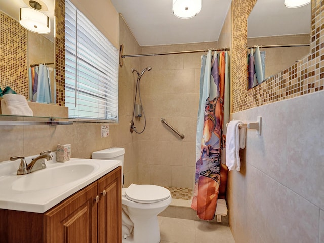 full bathroom featuring vanity, tile walls, toilet, tile patterned floors, and tiled shower