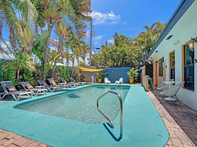 view of swimming pool featuring fence, a patio, and a fenced in pool