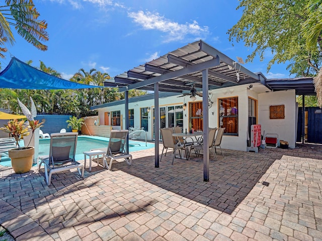view of patio featuring fence, outdoor dining area, and a fenced in pool