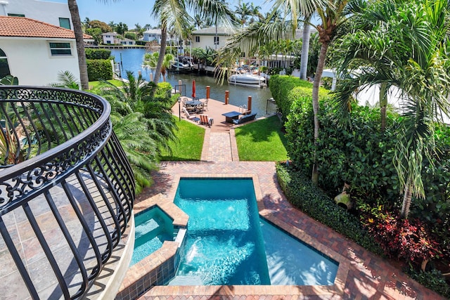 702 SE 7th St, Delray Beach, FL 33483 - view of pool with a water view, a dock, a pool with connected hot tub, a lawn, and a patio