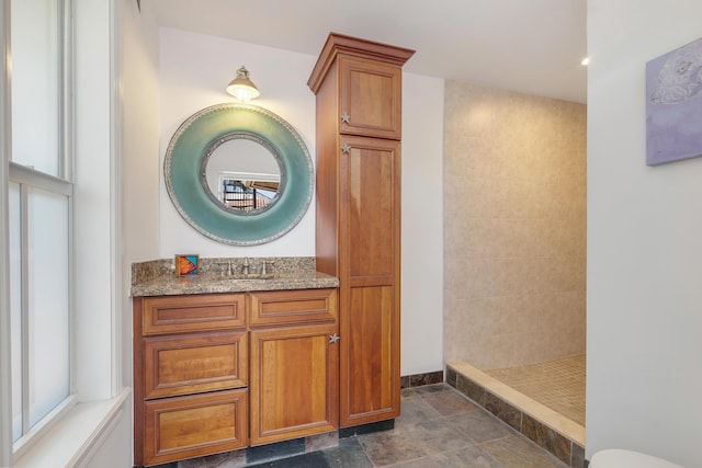 702 SE 7th St, Delray Beach, FL 33483 - full bathroom with walk in shower, vanity, and stone finish flooring