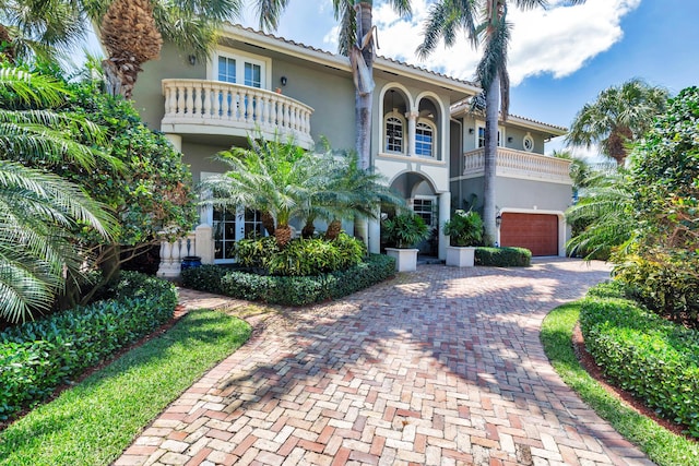 702 SE 7th St, Delray Beach, FL 33483 - mediterranean / spanish house with a balcony, stucco siding, decorative driveway, an attached garage, and a tile roof