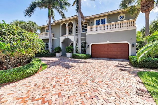 702 SE 7th St, Delray Beach, FL 33483 - mediterranean / spanish house with decorative driveway, stucco siding, a balcony, and a garage