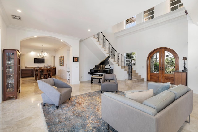 702 SE 7th St, Delray Beach, FL 33483 - living room with arched walkways, light marble finish floors, stairs, crown molding, and plenty of natural light