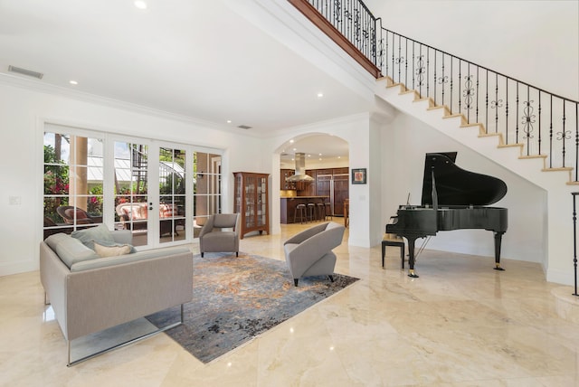 702 SE 7th St, Delray Beach, FL 33483 - living room with arched walkways, marble tiled floors, crown molding, baseboards, and recessed lighting