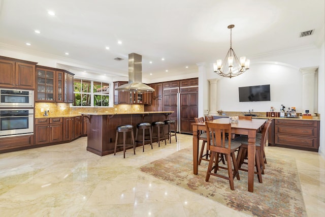 702 SE 7th St, Delray Beach, FL 33483 - dining room with crown molding, light marble finish floors, ornate columns, a chandelier, and recessed lighting