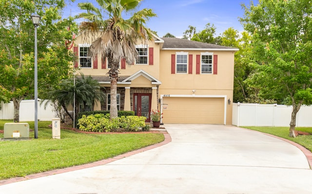 6102 NW Painted Bunting Ct, Port Saint Lucie, FL 34986 - view of front of house featuring concrete driveway, stucco siding, fence, and a front lawn