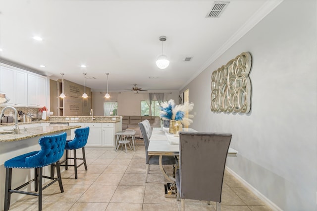 6102 NW Painted Bunting Ct, Port Saint Lucie, FL 34986 - dining room featuring light tile patterned flooring, baseboards, visible vents, ceiling fan, and ornamental molding