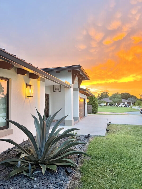 9600 Payton Ct, Boynton Beach, FL 33472 - view of side of home featuring a lawn, a garage, concrete driveway, and stucco siding