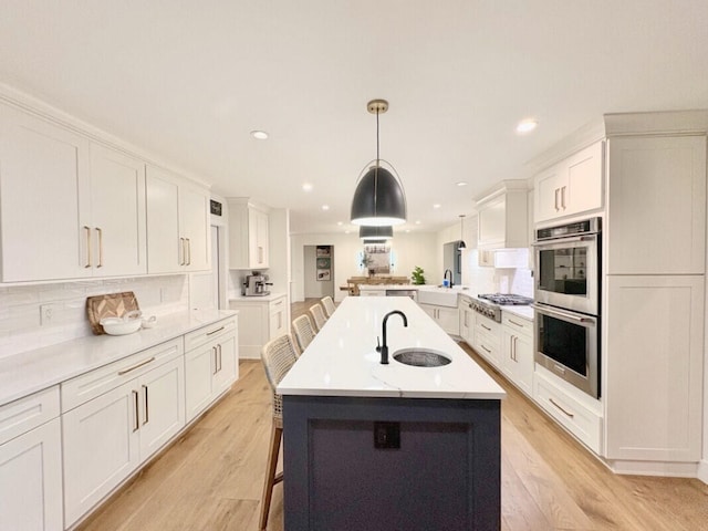 9600 Payton Ct, Boynton Beach, FL 33472 - kitchen featuring stainless steel appliances, a sink, backsplash, white cabinetry, and recessed lighting