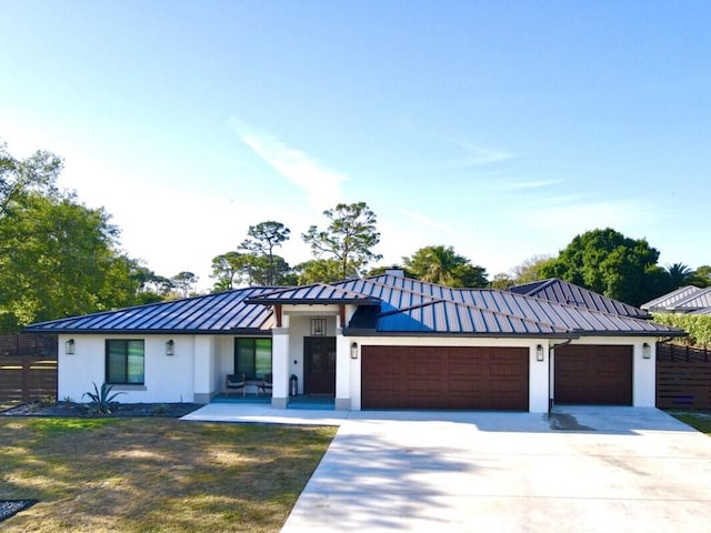 9600 Payton Ct, Boynton Beach, FL 33472 - view of front of property featuring a standing seam roof, metal roof, a garage, stucco siding, and concrete driveway