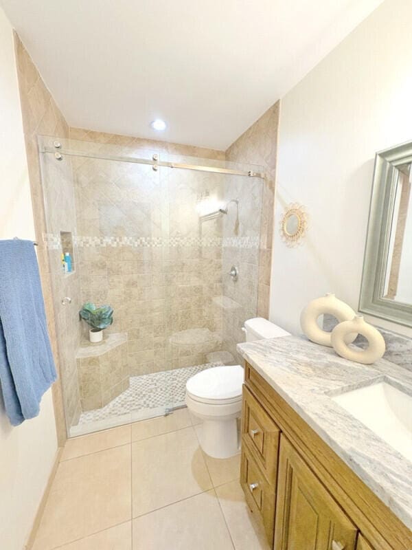 9600 Payton Ct, Boynton Beach, FL 33472 - full bathroom featuring vanity, a tile shower, toilet, and tile patterned floors