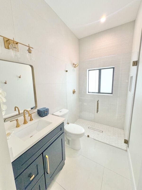 9600 Payton Ct, Boynton Beach, FL 33472 - full bath featuring a stall shower, vanity, tile patterned flooring, and toilet