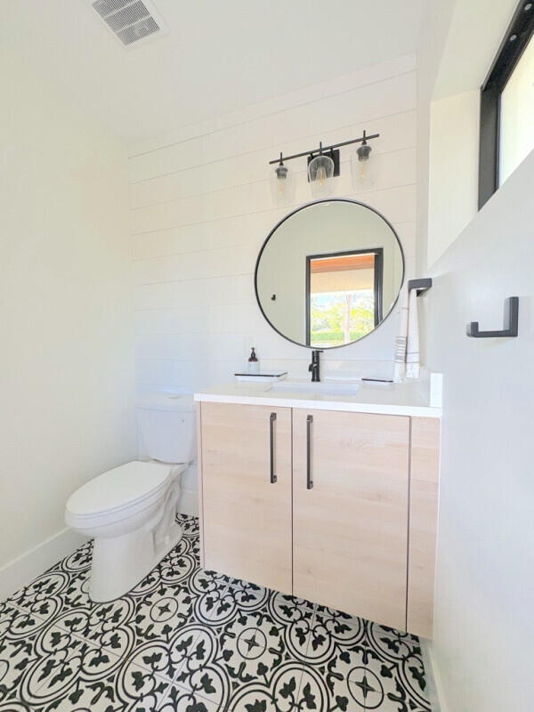 9600 Payton Ct, Boynton Beach, FL 33472 - half bath featuring toilet, vanity, and tile patterned flooring