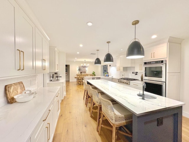 9600 Payton Ct, Boynton Beach, FL 33472 - kitchen featuring stainless steel appliances, backsplash, light wood-style flooring, white cabinetry, and recessed lighting