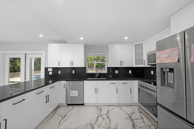 6008 S Citrus Ave, Fort Pierce, FL 34982 - kitchen with stainless steel appliances, light marble finish floors, tasteful backsplash, recessed lighting, and white cabinetry