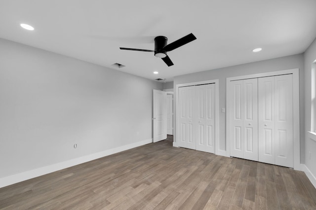 6008 S Citrus Ave, Fort Pierce, FL 34982 - unfurnished bedroom featuring multiple closets, wood finished floors, recessed lighting, and ceiling fan