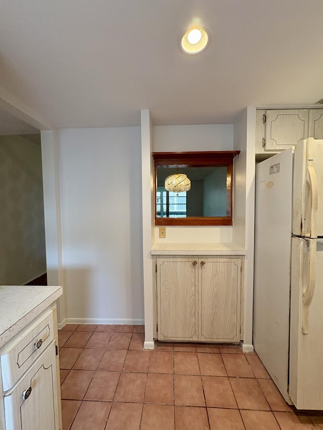 2540 Boundbrook Blvd Unit 110, Palm Springs, FL 33406 - kitchen with freestanding refrigerator, light countertops, and light tile patterned floors