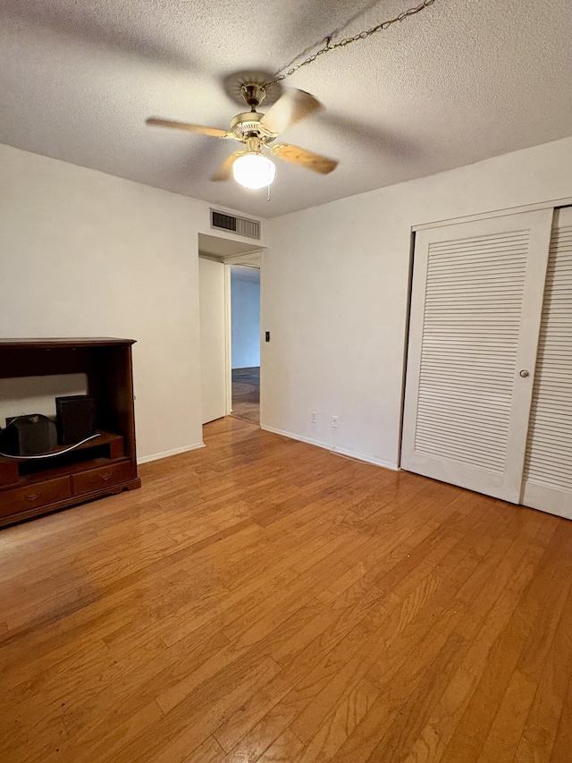 2540 Boundbrook Blvd Unit 110, Palm Springs, FL 33406 - unfurnished living room featuring a ceiling fan, a textured ceiling, and wood finished floors