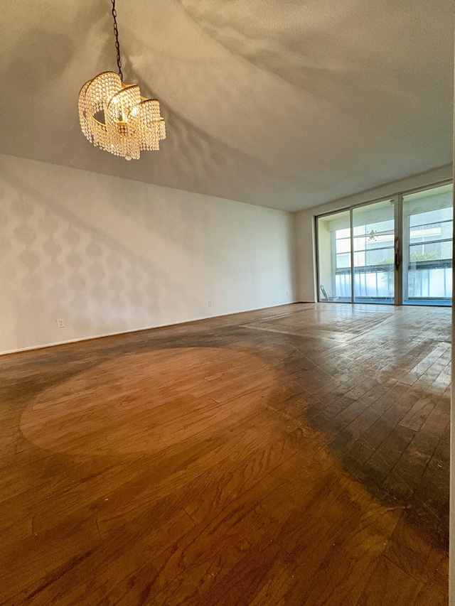 2540 Boundbrook Blvd Unit 110, Palm Springs, FL 33406 - unfurnished room featuring a chandelier and dark wood-type flooring