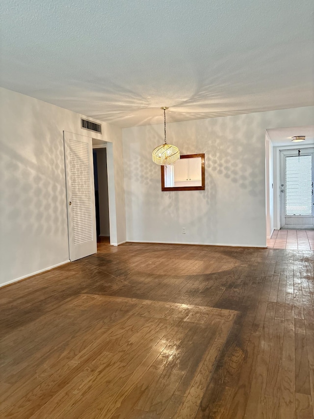 2540 Boundbrook Blvd Unit 110, Palm Springs, FL 33406 - empty room featuring wood-type flooring and a textured ceiling