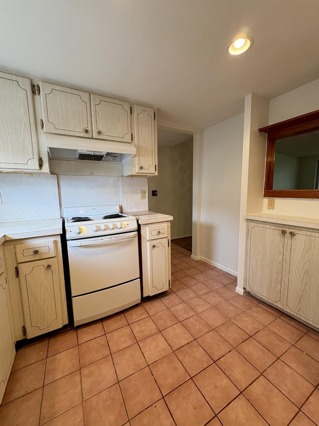 2540 Boundbrook Blvd Unit 110, Palm Springs, FL 33406 - kitchen featuring white electric range, under cabinet range hood, light countertops, backsplash, and light tile patterned flooring