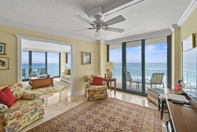 living room with a water view, ceiling fan, a textured ceiling, crown molding, and marble finish floor