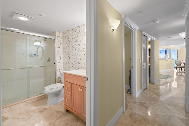 full bathroom with a shower stall, vanity, baseboards, and toilet