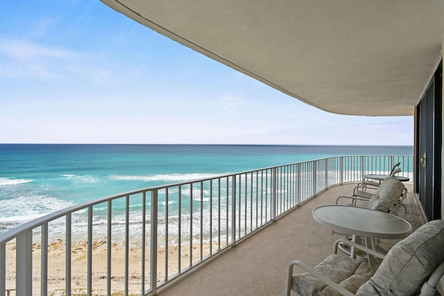 balcony with a beach view and a water view