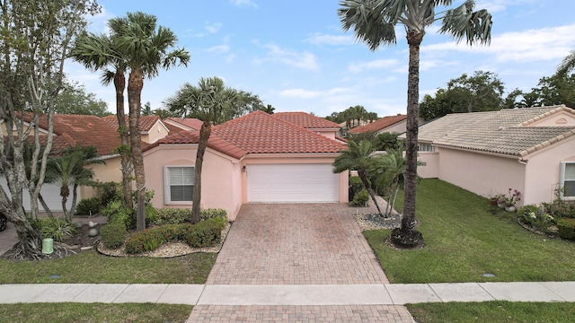 view of front of home featuring stucco siding, an attached garage, a tiled roof, decorative driveway, and a front yard