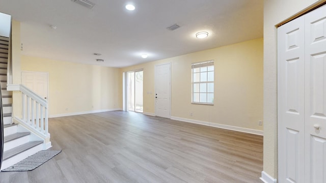 2558 SE Pineland Dr, Port Saint Lucie, FL 34952 - spare room with light wood-style flooring, visible vents, and stairway