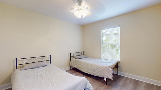 2558 SE Pineland Dr, Port Saint Lucie, FL 34952 - bedroom with baseboards and wood finished floors