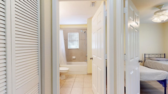 2558 SE Pineland Dr, Port Saint Lucie, FL 34952 - bathroom featuring shower / tub combo, toilet, a ceiling fan, ensuite bath, and tile patterned floors