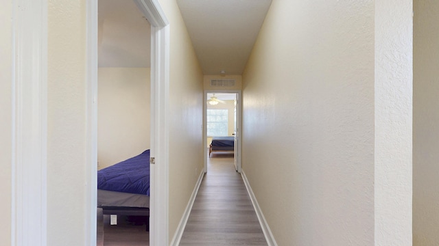 2558 SE Pineland Dr, Port Saint Lucie, FL 34952 - hall with wood finished floors, baseboards, and visible vents