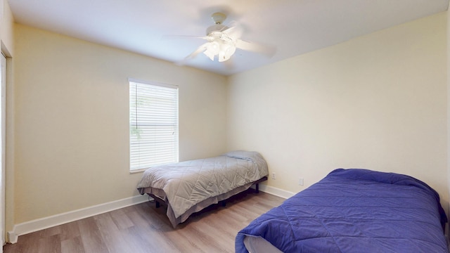 2558 SE Pineland Dr, Port Saint Lucie, FL 34952 - bedroom featuring wood finished floors, ceiling fan, and baseboards