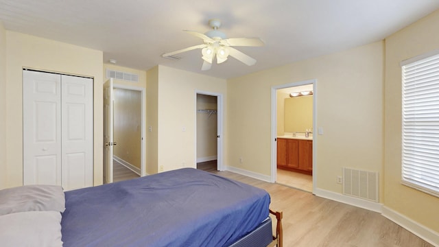 2558 SE Pineland Dr, Port Saint Lucie, FL 34952 - bedroom with visible vents, baseboards, multiple closets, and light wood-style flooring