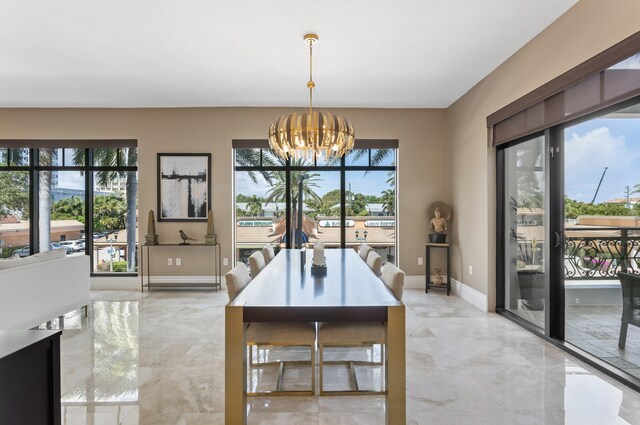 dining area featuring an inviting chandelier, marble finish floor, and baseboards