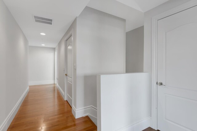 corridor featuring recessed lighting, baseboards, light wood finished floors, and visible vents
