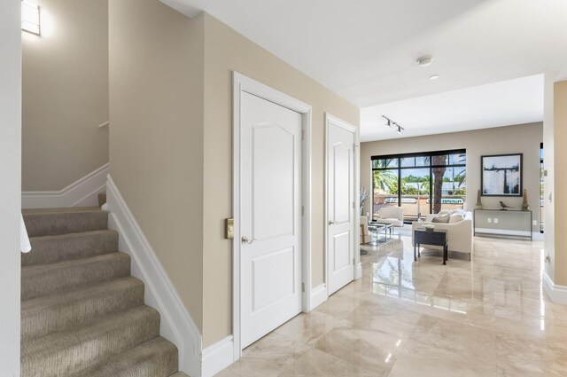 staircase with baseboards and marble finish floor