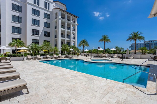 pool featuring a patio and a community hot tub