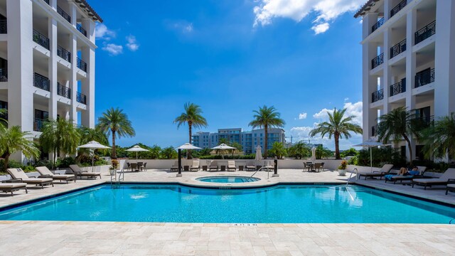 community pool featuring a patio and a community hot tub