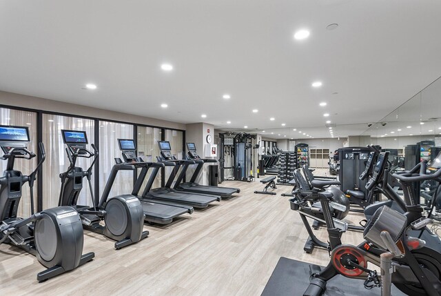 gym with recessed lighting and light wood-style flooring